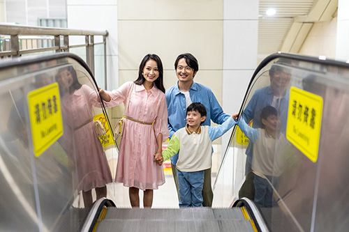 Family riding an escalator