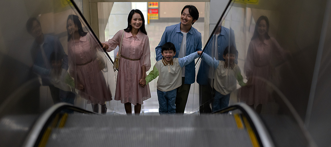 Family riding an escalator