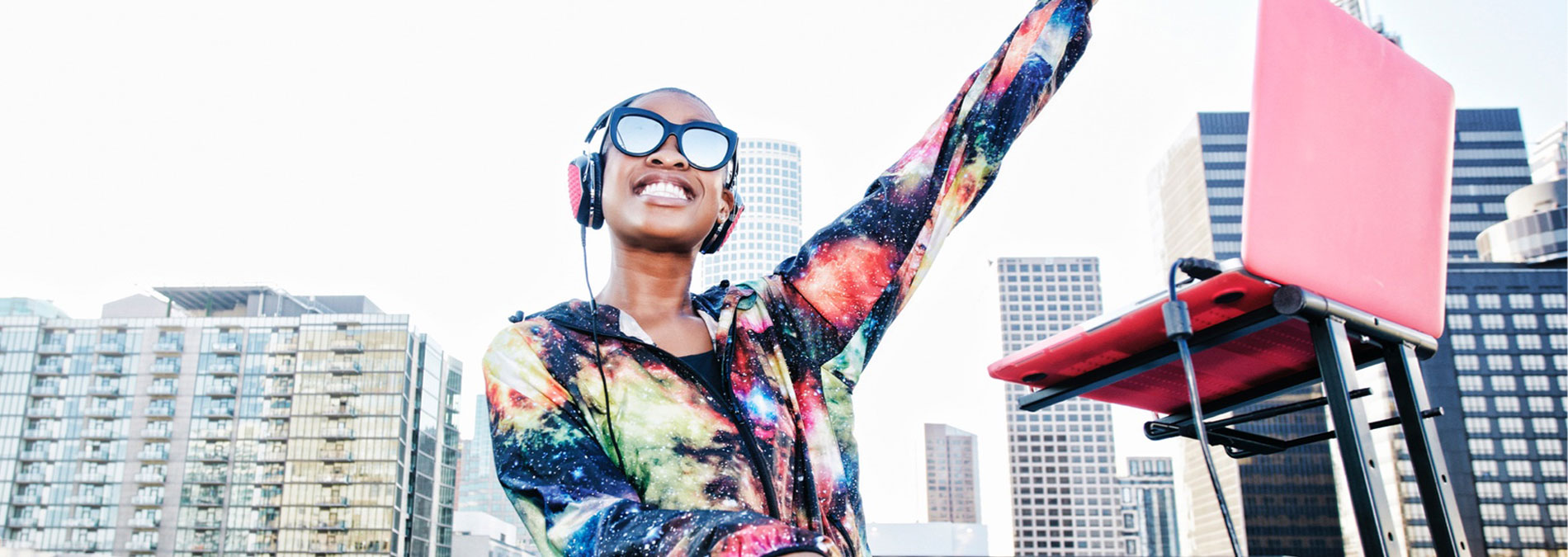 person with headset and computer smiling