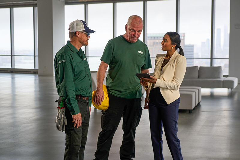 Otis employees on a job site